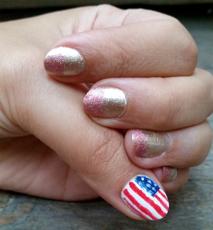 Nails with gold and rose polish. Thumb with American flag.